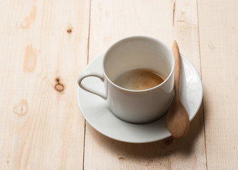 empty coffee cup on wood table, retro filter effect