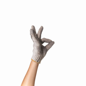 hand in  dirty work gloves with thumb up isolated on white backg