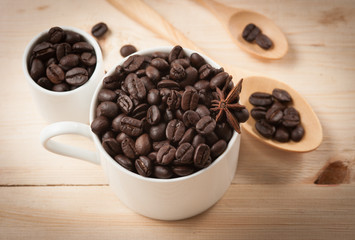 Coffee beans in cup on wood background,selective focus, retro fi