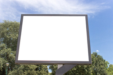 Blank billboard in a park with blue sky