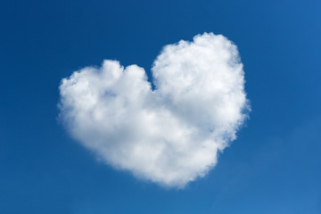 Naklejka na ściany i meble Heart shaped clouds on blue sky background