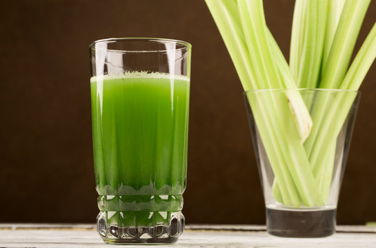 Glass of celery juice on the white table
