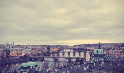 Panoramic view on Prague bridges and Vltava river on an early morning. Image filtered in faded, toned, retro, Instagram style; nostalgic vintage travel concept.