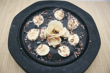Decorative and tasty fruit salad of bananas and chocolate