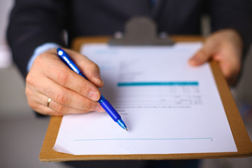 File folders, standing on shelves in the background
