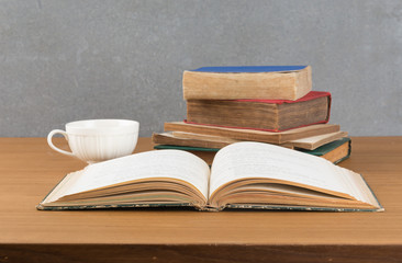 old book with books stack and coffee