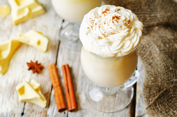 hot white chocolate decorated with whipped cream with cinnamon