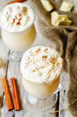 hot white chocolate decorated with whipped cream with cinnamon