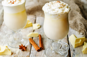 hot white chocolate decorated with whipped cream with cinnamon