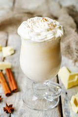 hot white chocolate decorated with whipped cream with cinnamon
