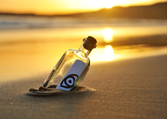 Bottle with message at sunset, eye