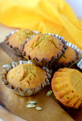 Sweet pumpkin muffins in metal molds .