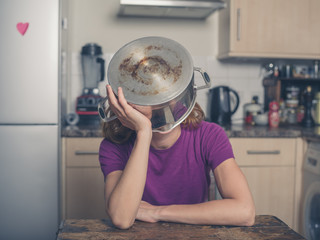 Concerned woman with pot on her head
