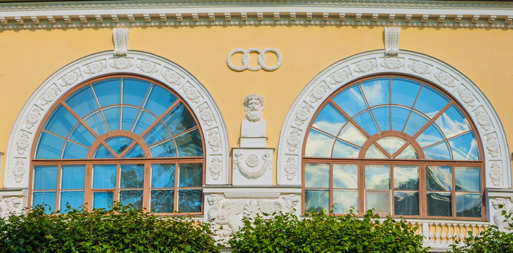 The windows in the antique style decorated with stucco and bas-reliefs