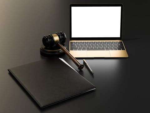 Wooden judges gavel and laptop computer on black table