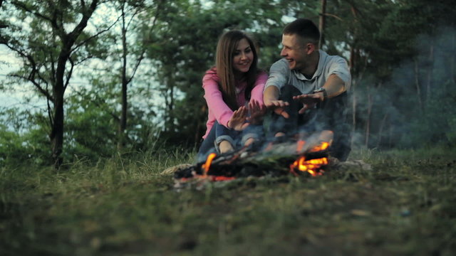 Couple camping in the autumn forest. Fall background