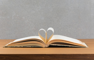 pages of a book curved into a heart shape