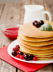 delicious pancakes on wooden table with fruits