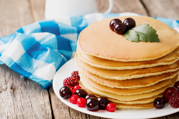 delicious pancakes on wooden table with fruits