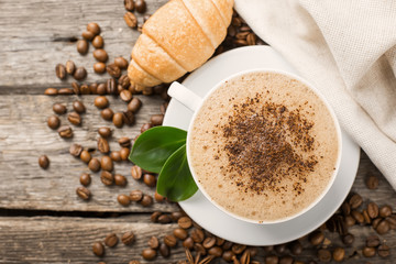 Hot coffee and pastries on a wooden background