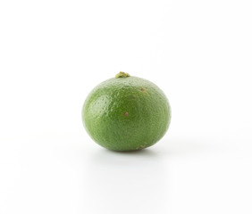green lemon isolated on white background