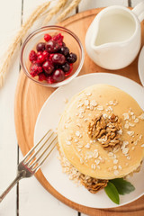 delicious pancakes on a wooden table with nuts