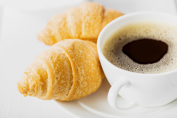 Hot cappuccino and pastries on white wooden boards