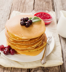 delicious pancakes on wooden table with fruits