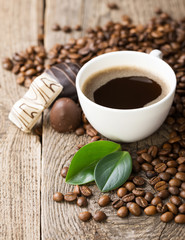 ground coffee in scoop and coffee beans on a wooden background, view from the top