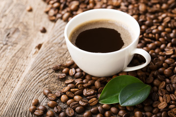 ground coffee in scoop and coffee beans on a wooden background, view from the top