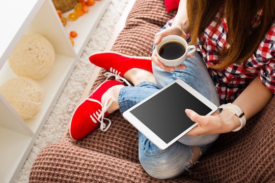 Woman At Home Relaxing On Sofa Couch Reading Email On The Tablet