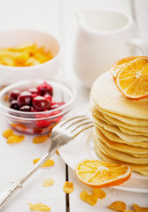delicious pancakes on wooden table with fruits