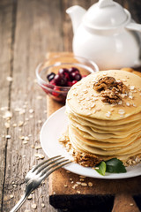 delicious pancakes on a wooden table with nuts