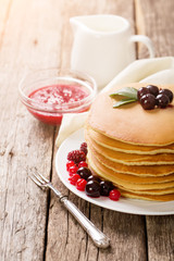 delicious pancakes on wooden table with fruits