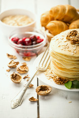 delicious pancakes on wooden table with fruits