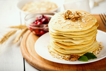 delicious pancakes on a wooden table with nuts