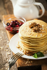 delicious pancakes on a wooden table with nuts