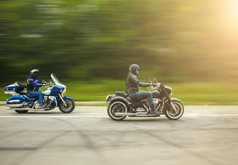 two bikers riding unknown motorbike with blur movement, speed co