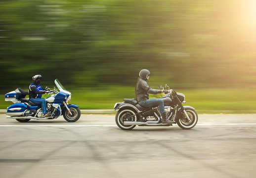 Fototapeta two bikers riding unknown motorbike with blur movement, speed co