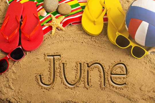 Summer concept of sandy beach, colorful thongs shoes, sunglasses