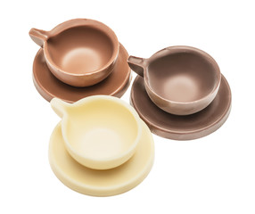Set of coffee cup, mug and the saucer made of milk, black and white chocolate. Isolated, on a white background