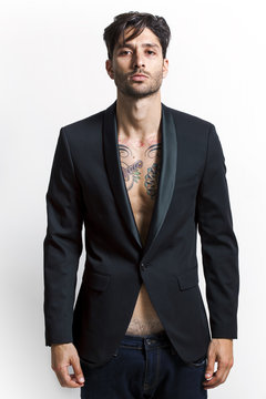Sexy tattooed man wearing black jacket