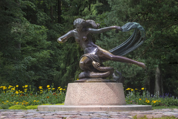 Girl's sculpture with grass-snake