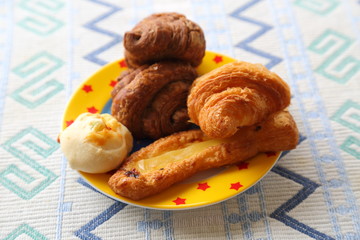 Breakfast of mini bread. Croissant, chocolate croissant, banana bread and green soybean bread.