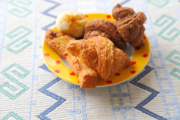 Breakfast of mini bread. Croissant, chocolate croissant, banana bread and green soybean bread.

