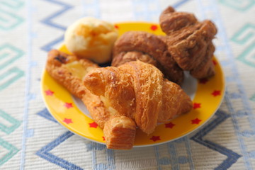 Breakfast of mini bread. Croissant, chocolate croissant, banana bread and green soybean bread.
