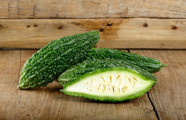 Green bitter gourd on the wooden background