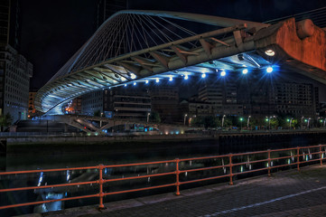 Zubizuri Bridge over Nevion River in Bilbao, Spain at night