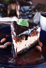 Delicious chocolate cake with icing in plate on table, closeup
