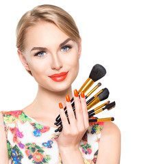 Beauty woman with makeup brushes. Natural make-up for blonde model girl with blue eyes